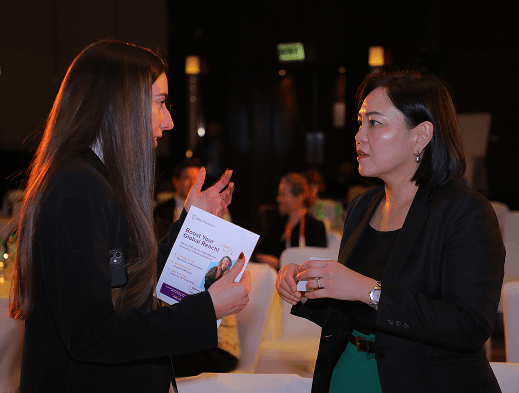Two women engaged in conversation at conference